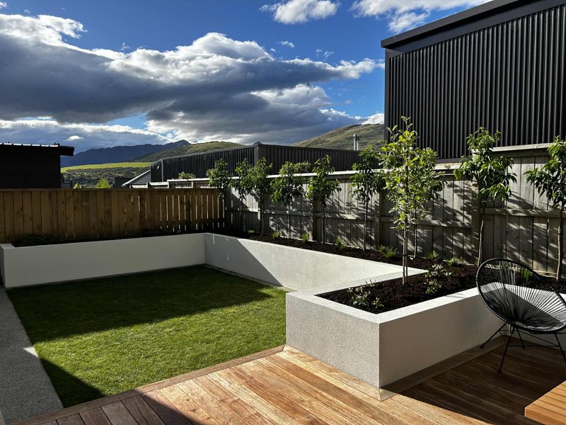 Landscaped lawn, planter boxes and hardwood deck at a completed Queenstown build