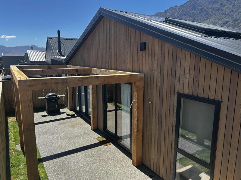 Timber-framed outdoor room off a cedar-clad house