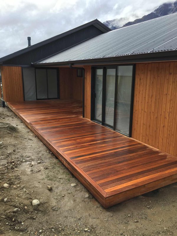 Hardwood deck wrapping around a cedar-clad home